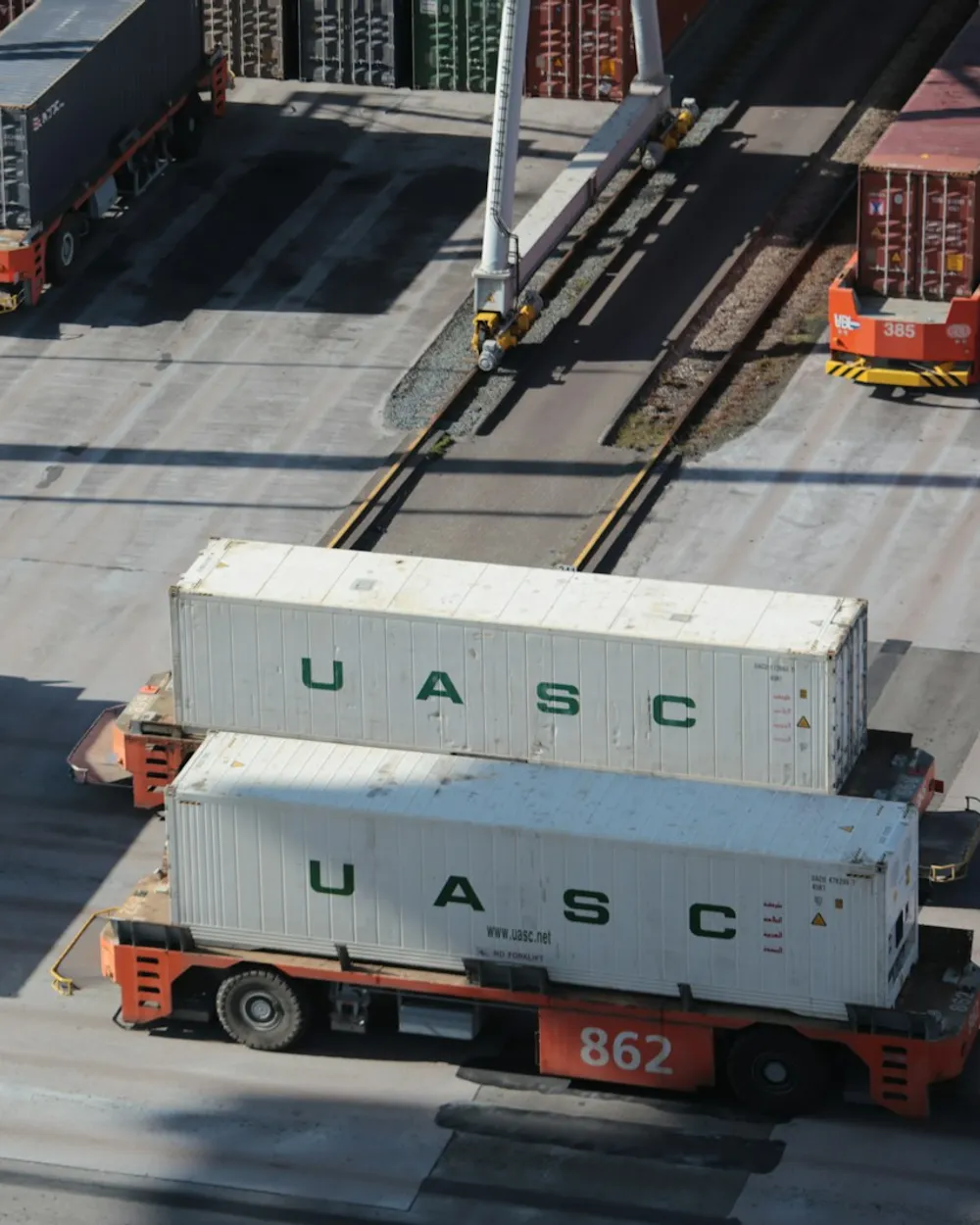 Shipping containers and delivery vans at a distribution yard